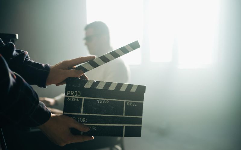 film production company clapperboard clipboard hands guy is directing filming