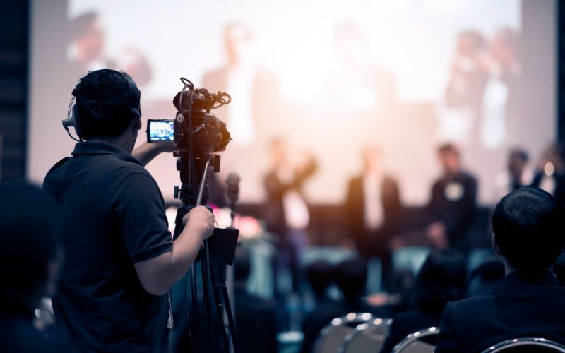 video production company camera operator working with his equipment indoor event